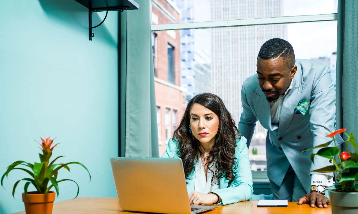 Staff working on an laptop together